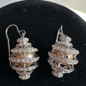 Silver colored earrings with pearls inside. CZ gems